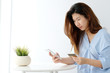 © mangpor2004 - Young asian woman holding credit card and using smart phone for shopping online, business and technology concept, online payment, digital money