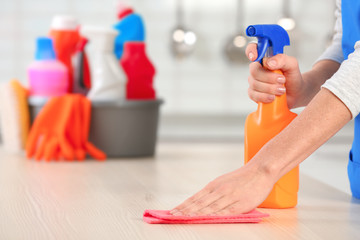 Sticker - Woman cleaning table with rag in kitchen, closeup. Space for text