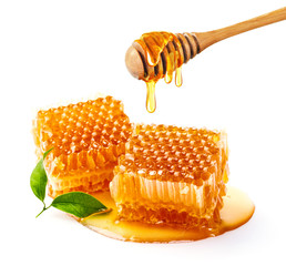 Sweet honeycomb and wooden Honey dripping isolated on a white background. Honey dipper