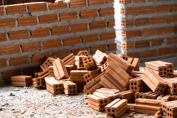 Wall Mural - Stack of Brick preparing for mansonry over the photo blurred of Bricks wall background,