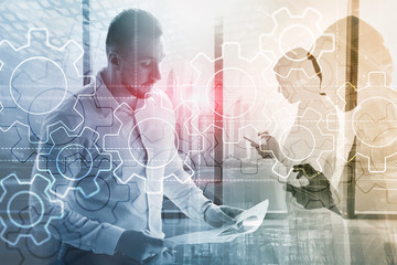 Wall Mural - double exposure gears mechanism on blurred background. business and industrial process automation co