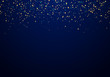 © rarinlada - Abstract falling golden glitter lights texture on a dark blue background with lighting.