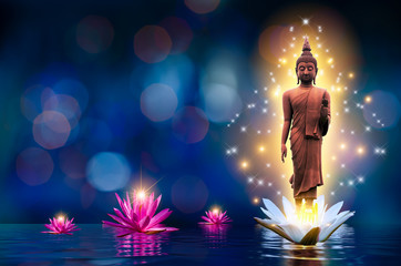 the buddha statue stands on a white and pink lotus in the water. bokeh blue background.