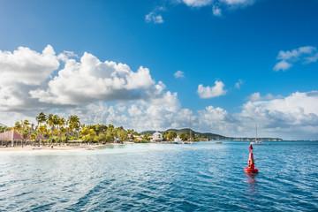 Wall Mural - Carebbean island with white beach. Red buoy in front of view.