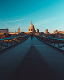 Fototapeta Londyn - Millennium Bridge St Paul's Cathedral on modern London city skyline blue sky