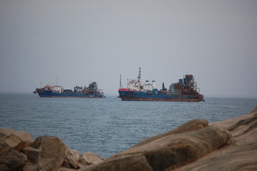 Diamond mining ships anchored ina bay before a storm