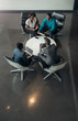 © JonoErasmus - Group of African business people sitting and discussing statistics during a sit down meeting taking from above