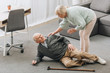 © LIGHTFIELD STUDIOS - old woman looking at husband who falled down on floor