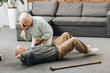 © LIGHTFIELD STUDIOS - senior woman holding hand of dying old man with walking stick