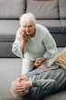 © LIGHTFIELD STUDIOS - senior woman helping old husband who falled down on floor