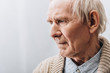 close up of sad pensioner with grey hair at home