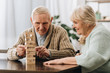 © LIGHTFIELD STUDIOS - retired husband and wife playing jenga game on table