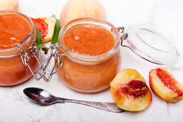 Wall Mural - Homemade peach jam with organic fruit. Sweet preserves on a light background