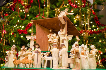 Christmas nativity scene with blurred Chrstmas tree in background