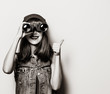 © Masson - Portrait of young style hipster girl with binoculars . Image in black and white color style