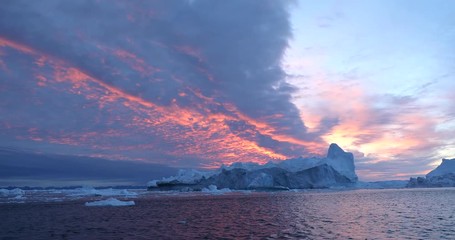 Wall Mural - photogenic and intricate iceberg under an interesting and colorful sky during sunset. disko bay, gre