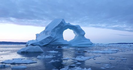 Wall Mural - photogenic and intricate iceberg under an interesting and colorful sky during sunset. disko bay, gre