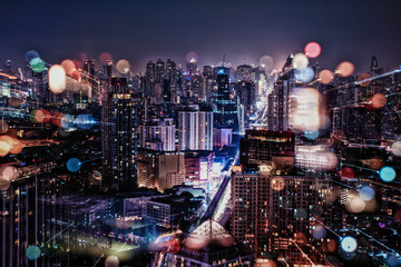 Papier Peint - Cityscape in the night with blur of city light and zoom in lens camera