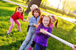 © Evgeniy Kalinovskiy - Children play tug of war in the park. Children's Day, June 1, friendship, childhood, vacation, camp