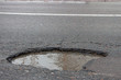there are many potholes on the roadway close up