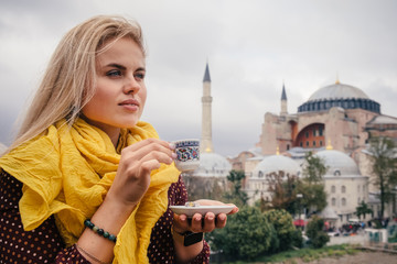 Woman with turkish coffee on Hagia Sophia bacground, Istanbul