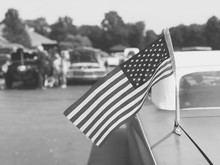 Vintage American Flag On Old Classic Car At Cruise In Car Show, Black And White Retro Style