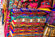 A lot of different colorful fabric coverlets on the souvenir store in Bolivia
