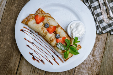 Wall Mural - Pancakes with berries and sour cream
