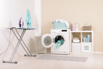 Wall Mural - Washing machine with towels in laundry room interior