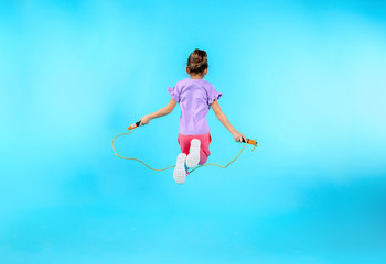 Sticker - Active girl jumping rope on color background