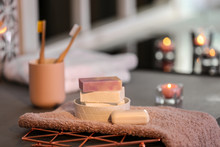 Soap Bars And Towel On Table Against Blurred Background. Space For Text