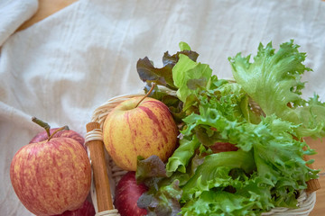 Apple and vegetable in wicker basket