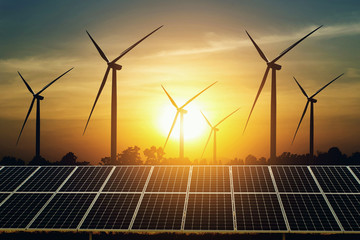 Wall Mural - solar panel and turbine with sunset background. clean energy power in nature concept