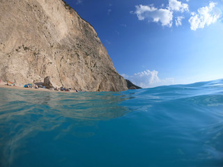 Underwater photo of mediterranean paradise island sandy beach with turquoise clear sea