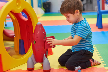 child of three years old is playing in the child's garden. boy smiling spends fun time in the children's room