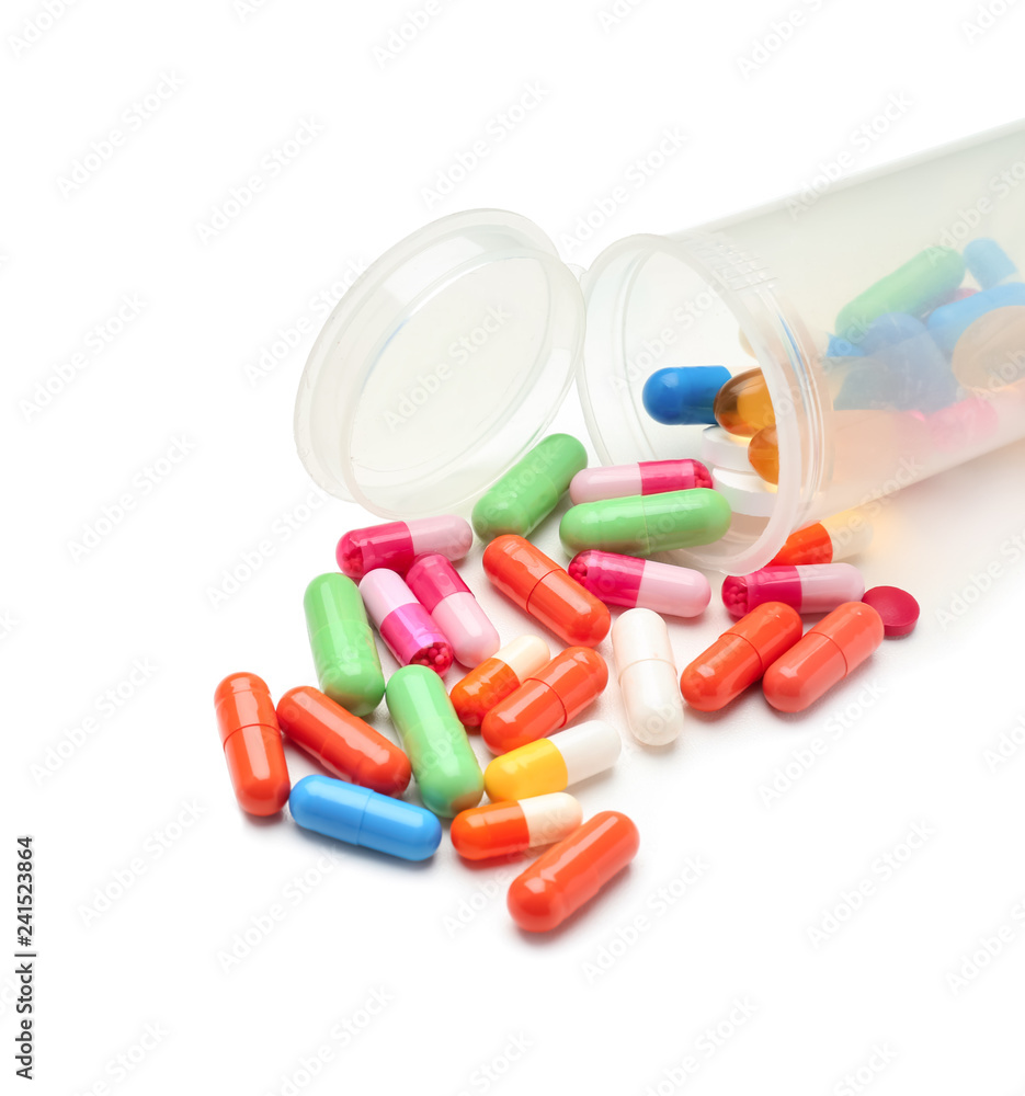 Container with color pills on white background