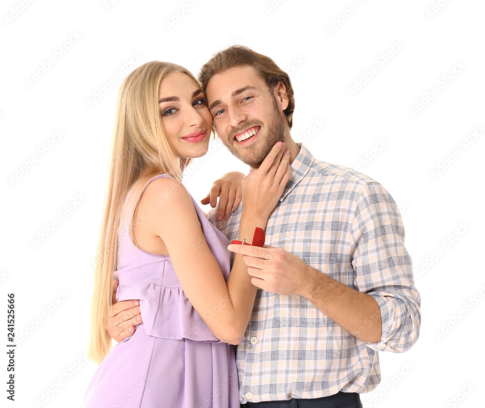 Young man proposing to his beloved on white background