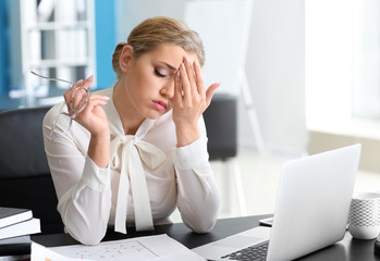 Wall Mural - Tired businesswoman working in office