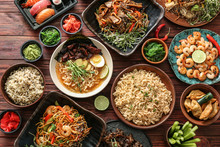 Assortment Of Chinese Food On Wooden Table