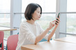 © Xiuxia Huang - Asian female using smartphone