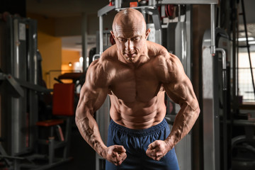  Muscular man posing in gym