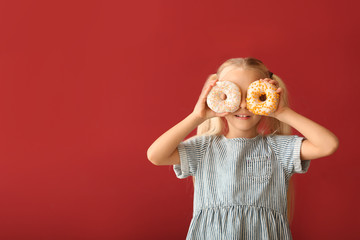 Sticker - Cute little girl with donuts on color background