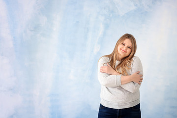 Wall Mural - Beautiful plus size girl on color background. Concept of body positivity