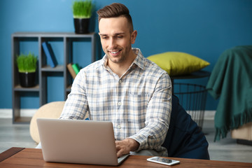 Sticker - Young man working with laptop at home