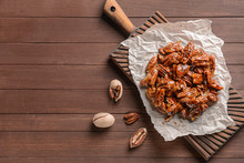Tasty Candied Pecan Nuts On Wooden Table