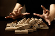 business failuare ideas concept with hand protect wooden stack block on ground with anger.