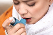 © Pixel-Shot - Young woman with inhaler having asthma attack outdoors, closeup
