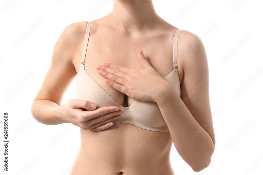 Young woman checking her breast on white background. Cancer awareness concept