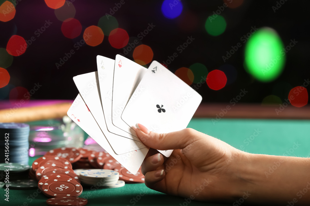 Woman playing cards in casino, closeup