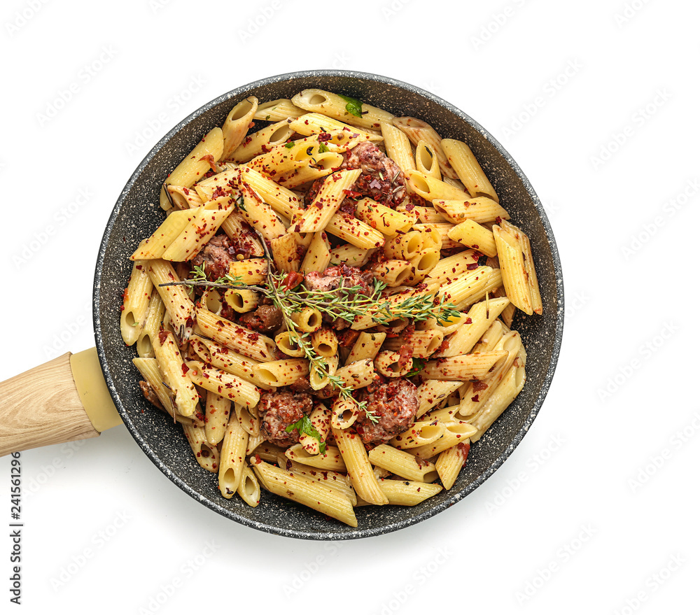 Tasty pasta with meat and spices in pan on white background
